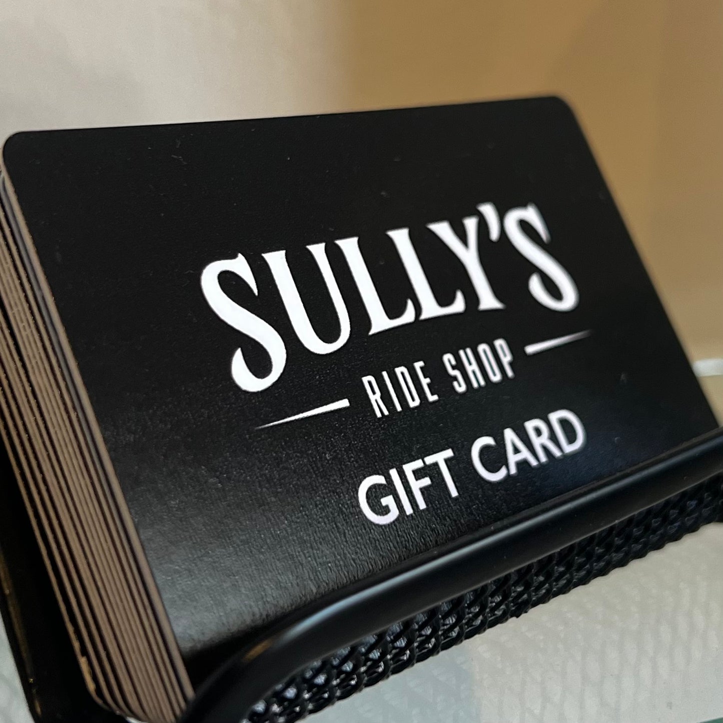 Sully's Ride Shop Gift Card physical version on display in stack
