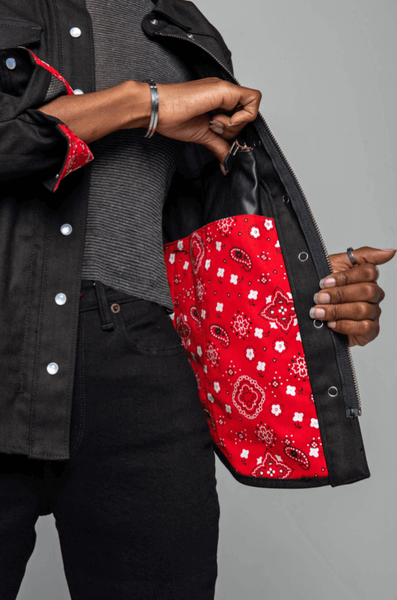 A model showing the red bandana lining and inner pocket of a Riveter Riding Shirt for motorcycle riding