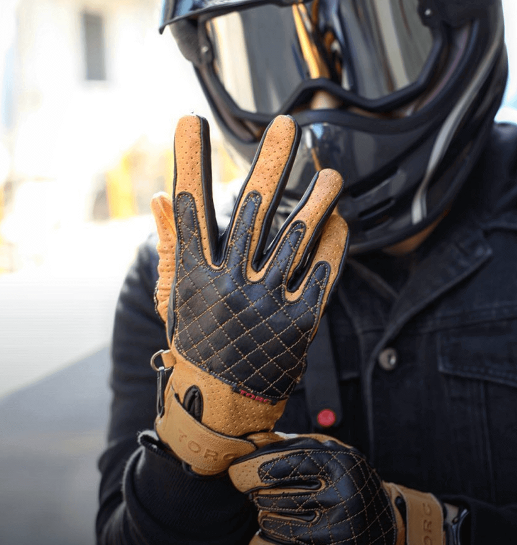 Torc Sunset Gold Motorcycle Glove being put on by classic biker