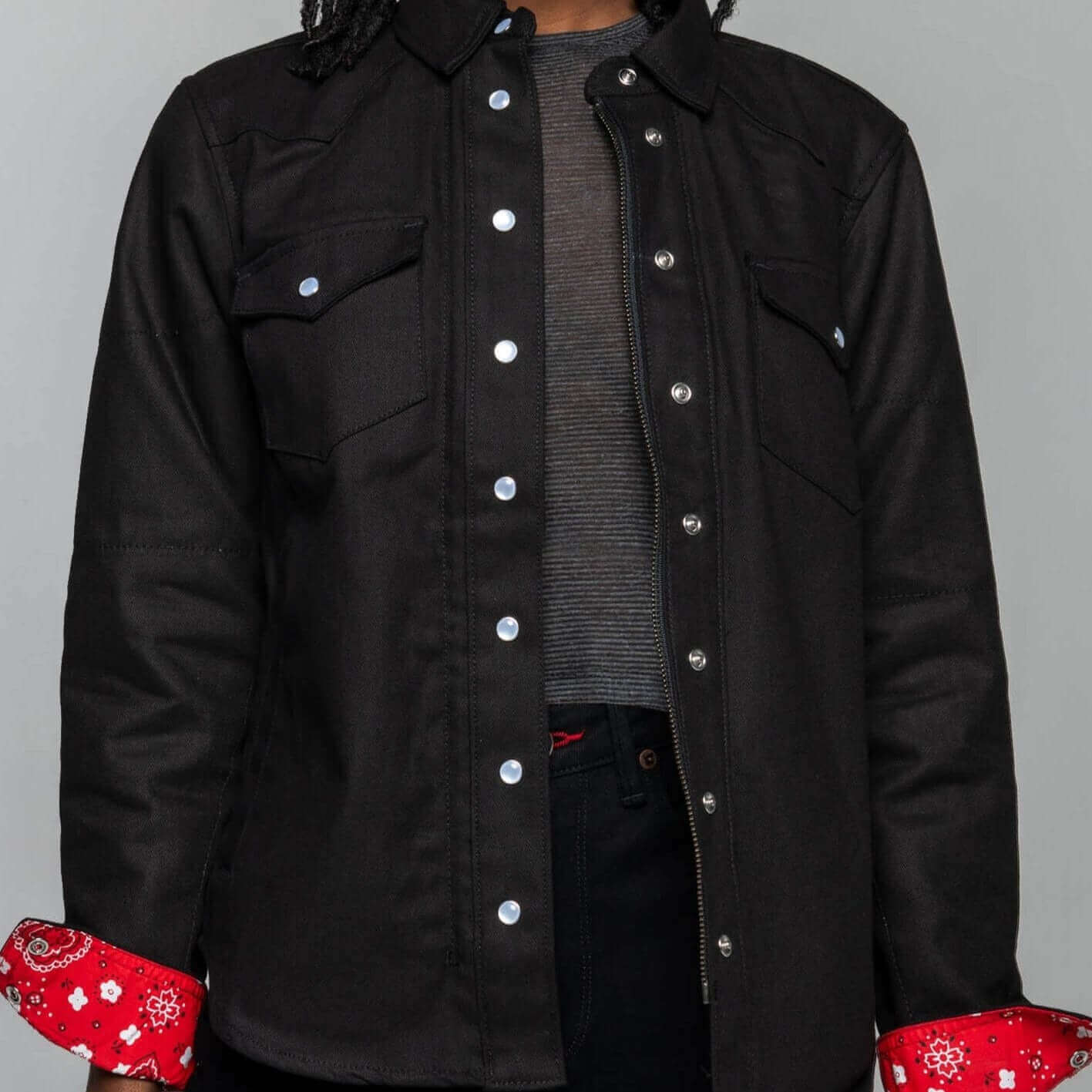 A woman facing forward wearing an open Riveter Riding Shirt for motorcycle riding