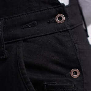 A close up of metal hip buttons on Tobacco Boondocks overalls