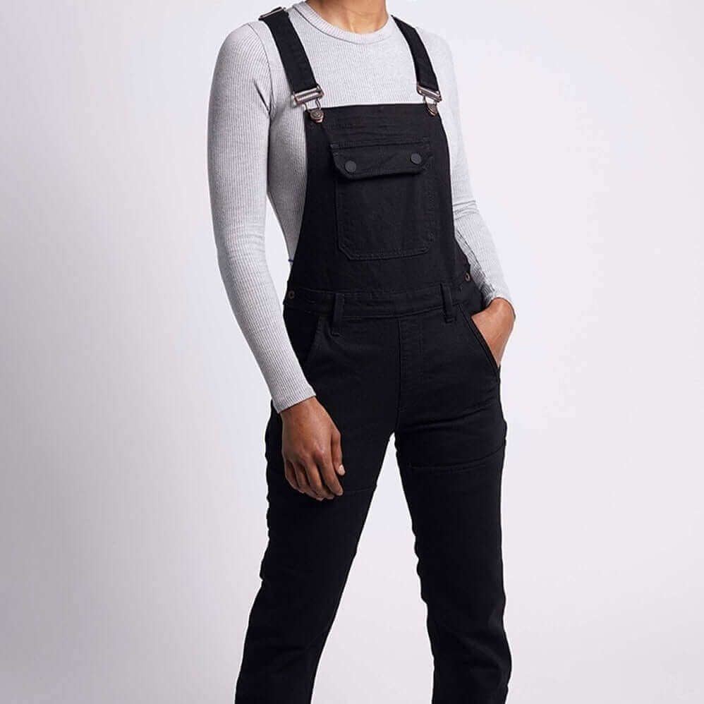 A front full body view of a female model wearing Tobacco Boondocks overalls